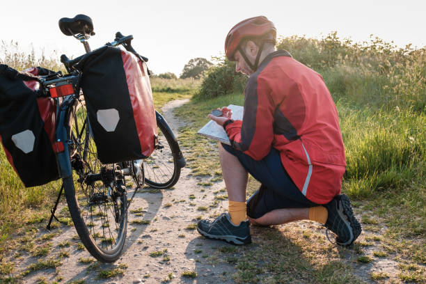 Cyclist writing in a journal after completing a ride