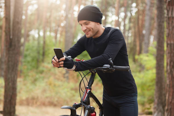 Cyclist using a phone to log mood and energy after a ride